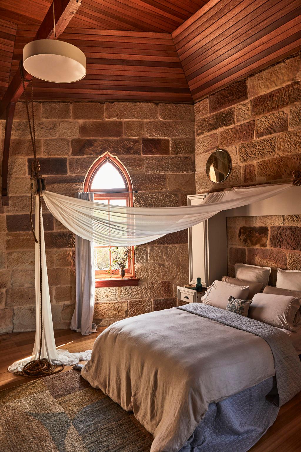 stone room with canopy bed