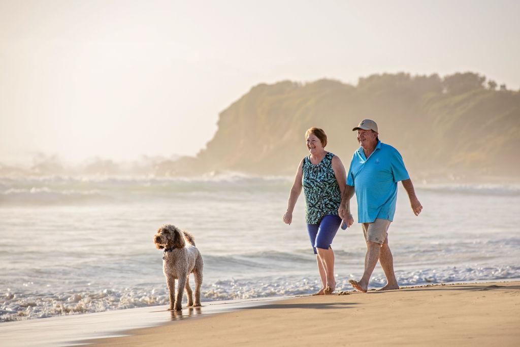 Couple walking on Narooma Beach